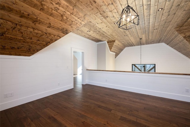 bonus room featuring a notable chandelier, wood ceiling, dark wood-type flooring, and vaulted ceiling