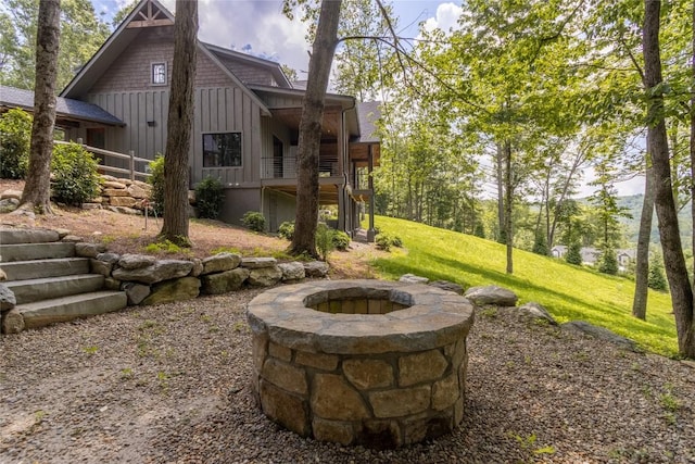 237 Glassy Rock Ln, Glenville, NC 28736 - rear view of property with board and batten siding, an outdoor fire pit, and a yard