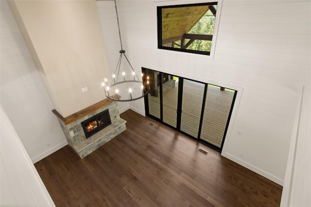 237 Glassy Rock Ln, Glenville, NC 28736 - unfurnished living room featuring a chandelier, dark wood-style floors, and a fireplace