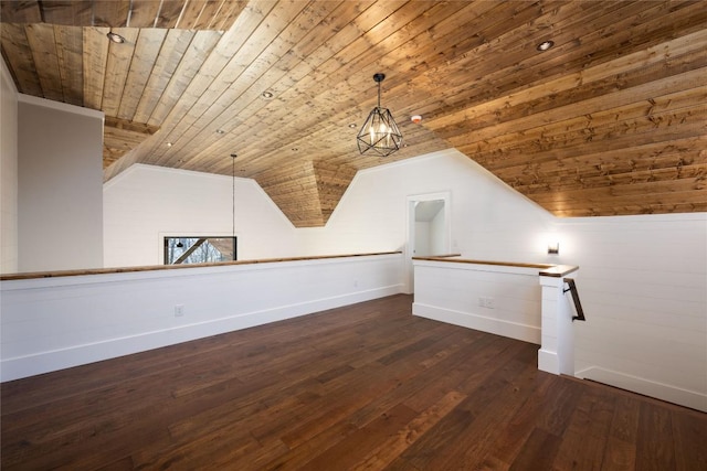 additional living space with wood ceiling, baseboards, vaulted ceiling, and wood finished floors