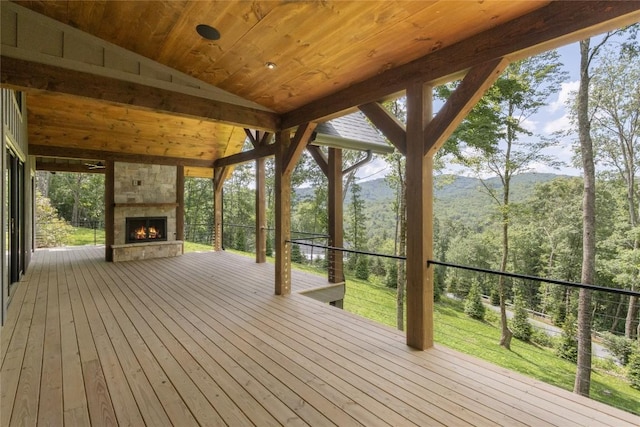 237 Glassy Rock Ln, Glenville, NC 28736 - wooden deck featuring an outdoor stone fireplace, a mountain view, and a wooded view
