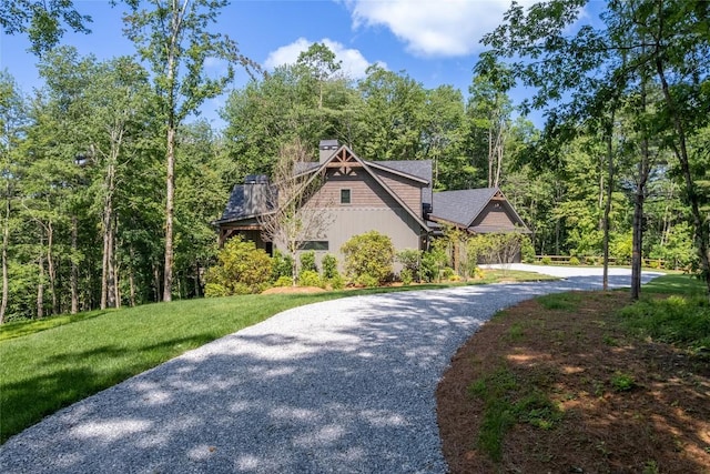 237 Glassy Rock Ln, Glenville, NC 28736 - view of front facade featuring gravel driveway, a front yard, a view of trees, and a chimney