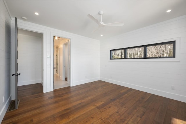 unfurnished bedroom with visible vents, a ceiling fan, baseboards, and dark wood finished floors