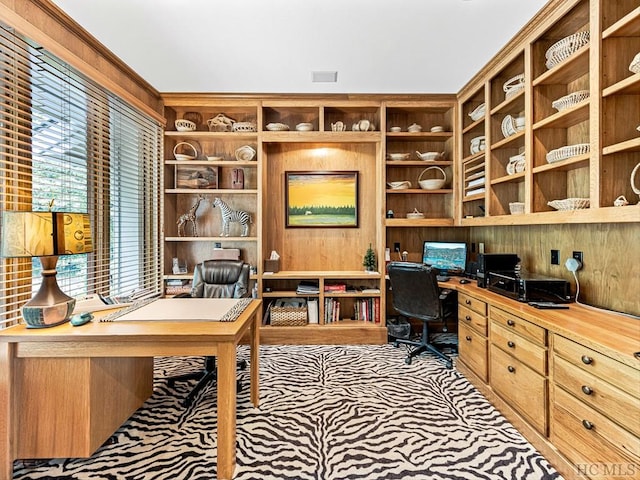 carpeted home office with built in desk