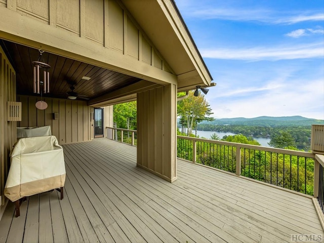 deck featuring ceiling fan and a water and mountain view