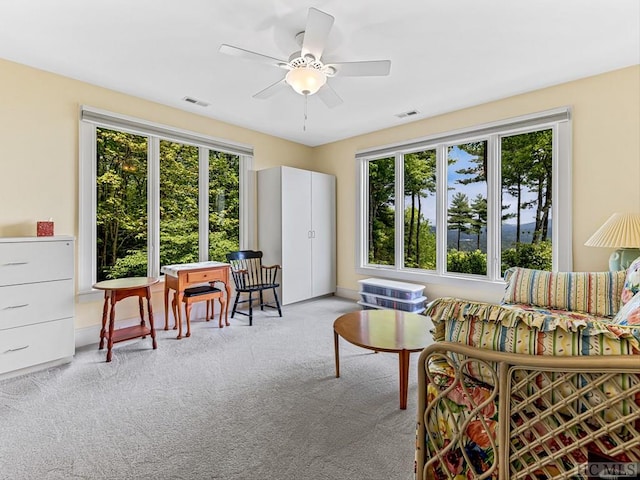 living room with ceiling fan and light carpet