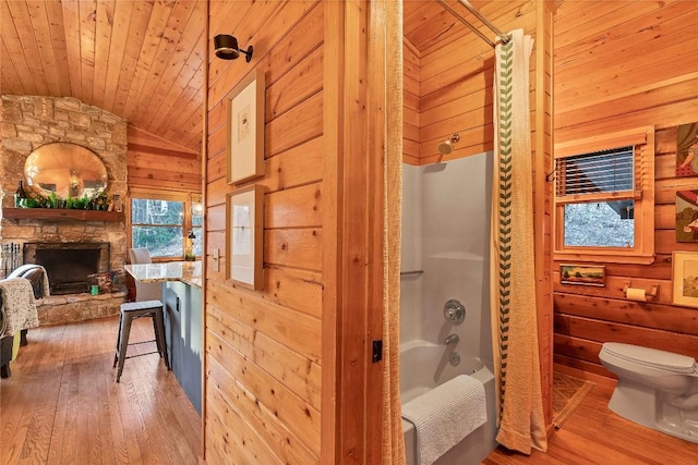 bathroom with wooden walls, toilet, lofted ceiling, wood ceiling, and hardwood / wood-style floors