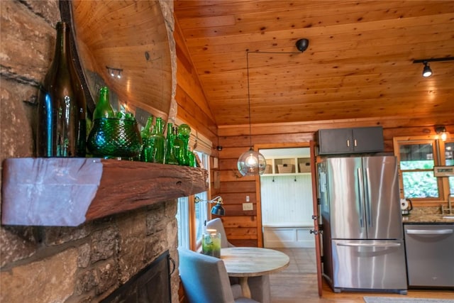 kitchen with appliances with stainless steel finishes, wooden ceiling, lofted ceiling, rail lighting, and light wood-style flooring