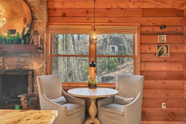 dining area with lofted ceiling and a fireplace