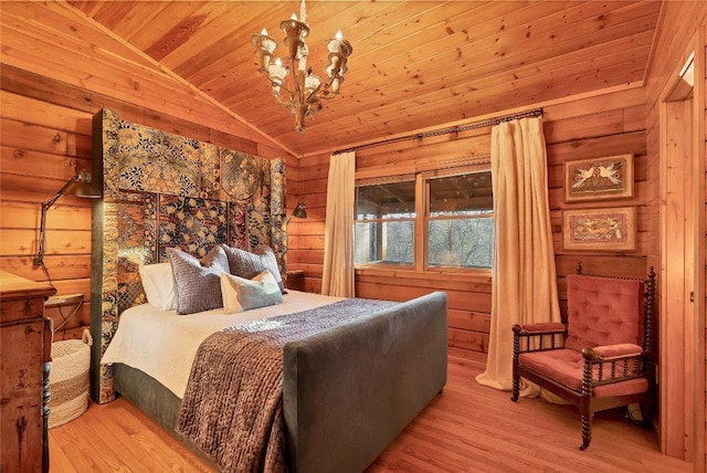 bedroom with an inviting chandelier, wood ceiling, wooden walls, and vaulted ceiling