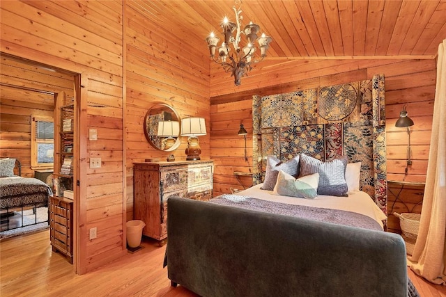 bedroom with a chandelier, light wood-style flooring, wooden walls, wood ceiling, and vaulted ceiling