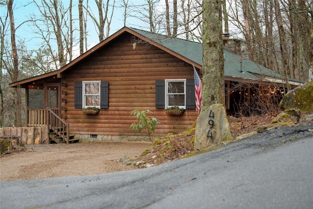 view of home's exterior featuring crawl space and roof with shingles