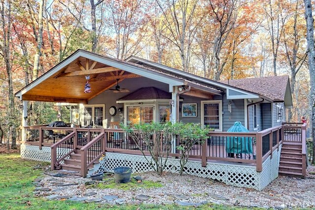 view of front of house with a wooden deck and ceiling fan