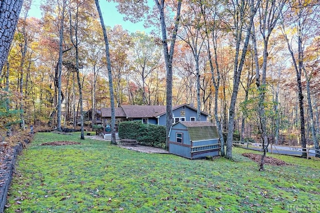 view of front of property with a shed and a front lawn