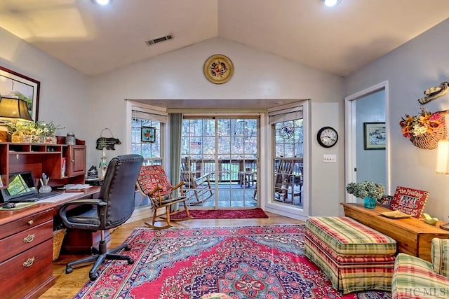 home office featuring light hardwood / wood-style floors and lofted ceiling