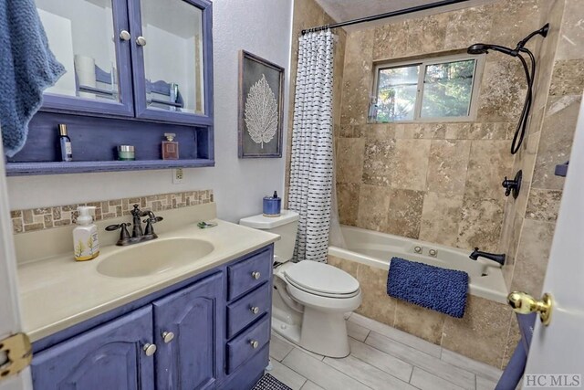 full bathroom featuring toilet, vanity, shower / bathtub combination with curtain, tile patterned flooring, and backsplash