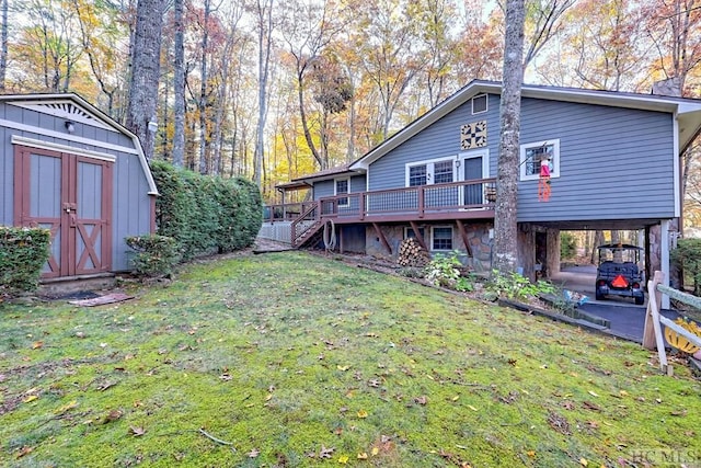 rear view of property featuring a carport, a yard, a deck, and a shed