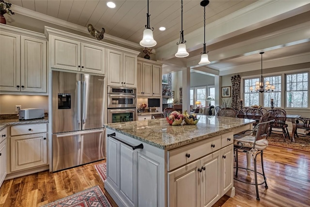 35 Creekwood Ct, Highlands, NC 28741 - kitchen featuring appliances with stainless steel finishes, recessed lighting, ornamental molding, light wood finished floors, and a kitchen island