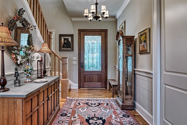 35 Creekwood Ct, Highlands, NC 28741 - foyer featuring light wood-type flooring, a chandelier, stairs, crown molding, and baseboards