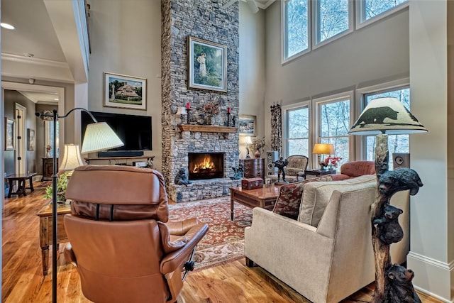 35 Creekwood Ct, Highlands, NC 28741 - living area featuring a high ceiling, a fireplace, wood finished floors, ornamental molding, and baseboards