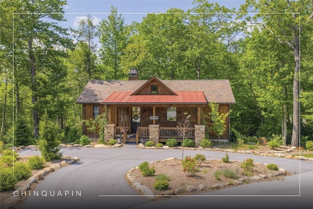 359 Outpost Trl, Glenville, NC 28736 - rustic home with covered porch, curved driveway, metal roof, and a standing seam roof
