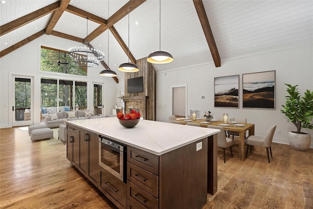 2147 Pilot Knob Rd, Glenville, NC 28736 - kitchen with high vaulted ceiling, stainless steel microwave, beam ceiling, and dark brown cabinetry