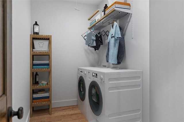 2147 Pilot Knob Rd, Glenville, NC 28736 - laundry room featuring washing machine and clothes dryer, laundry area, baseboards, and light wood-style flooring