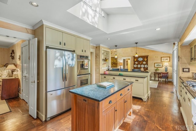 kitchen featuring a peninsula, appliances with stainless steel finishes, dark wood-style floors, dark countertops, and crown molding