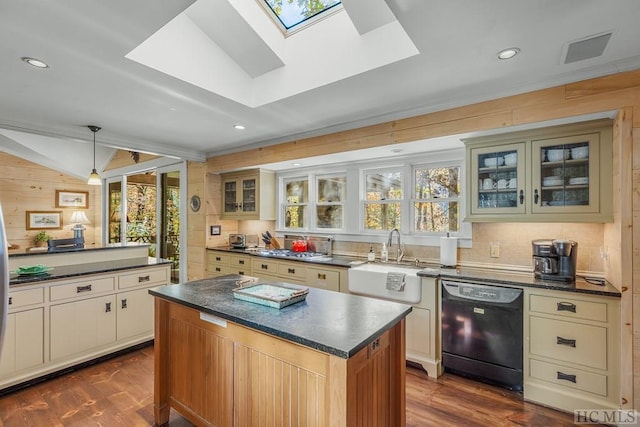 kitchen with dark countertops, black dishwasher, a healthy amount of sunlight, and a sink