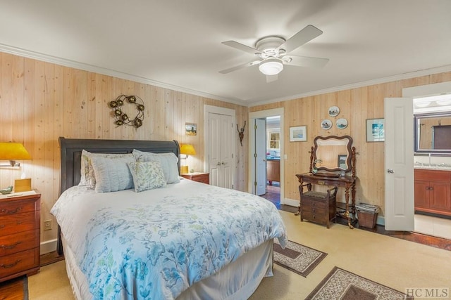 bedroom featuring baseboards, a ceiling fan, connected bathroom, ornamental molding, and a closet