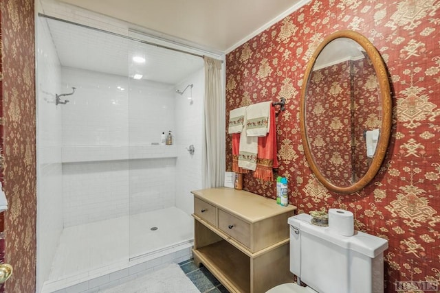 bathroom with a shower stall and wallpapered walls