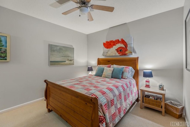 carpeted bedroom with a ceiling fan and baseboards