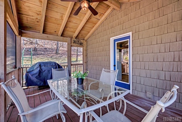 wooden terrace with ceiling fan and a grill