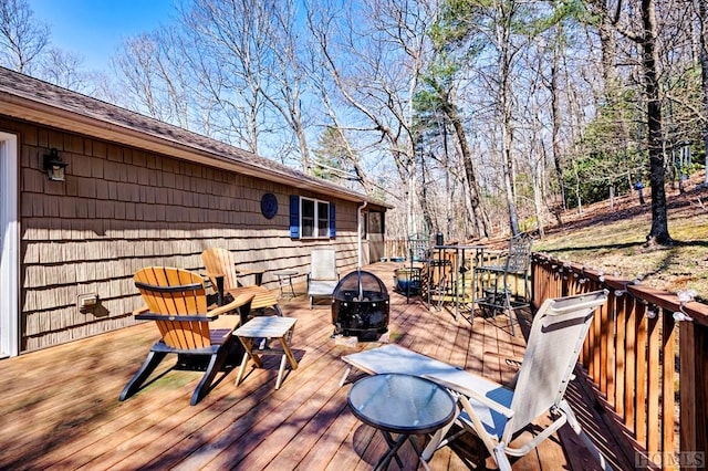 wooden terrace featuring an outdoor fire pit