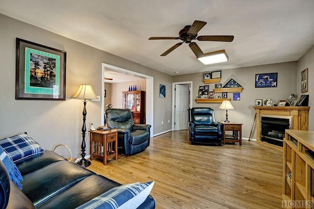 living room featuring hardwood / wood-style floors and ceiling fan