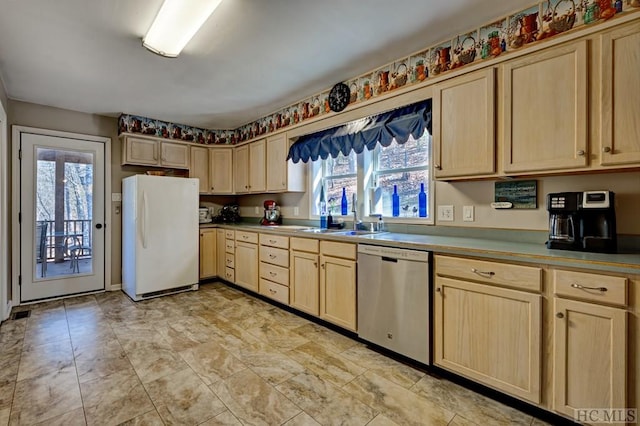 kitchen with sink, stainless steel dishwasher, white fridge, and light brown cabinetry