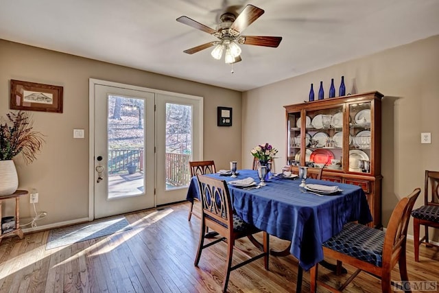 dining space with light hardwood / wood-style floors and ceiling fan