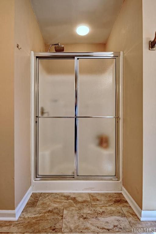 bathroom featuring a shower with door