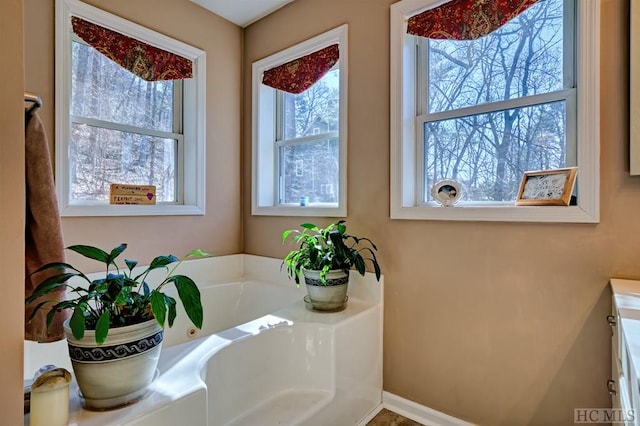 bathroom with a tub and vanity