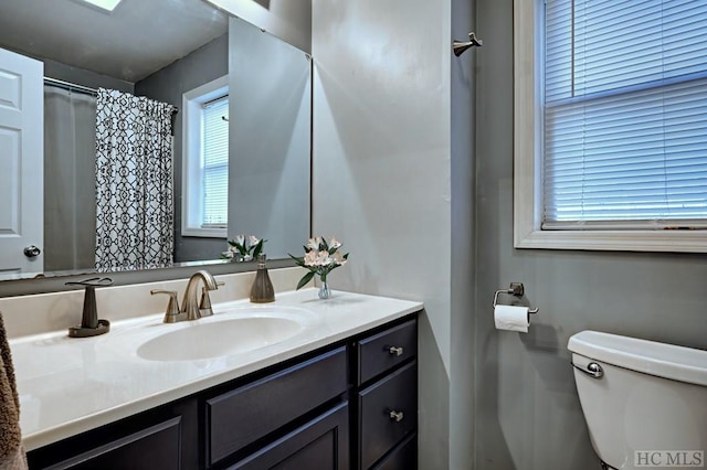 bathroom featuring vanity and toilet