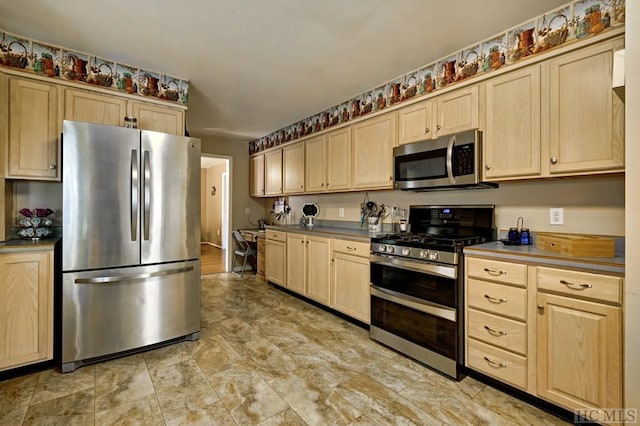 kitchen featuring stainless steel appliances and light brown cabinets