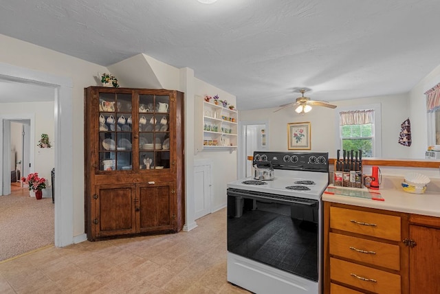 232 Dobson Rd, Franklin, NC 28734 - kitchen with range with electric stovetop, light countertops, a ceiling fan, and brown cabinetry