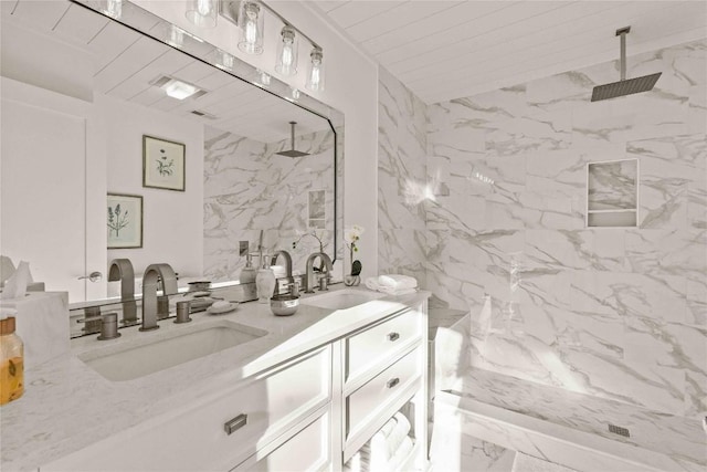 full bathroom with a marble finish shower, double vanity, and marble finish flooring