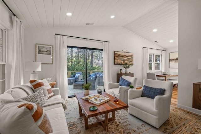 living room featuring lofted ceiling, plenty of natural light, recessed lighting, wood finished floors, and baseboards