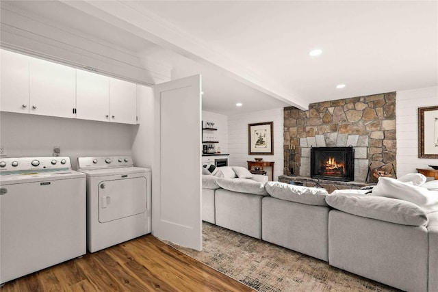 laundry room with washer and dryer, wood finished floors, and a fireplace