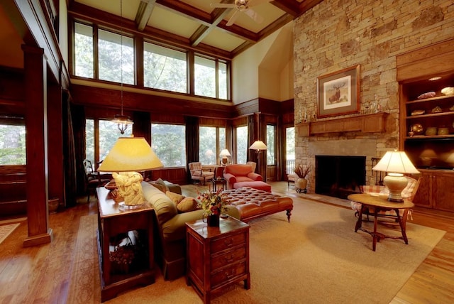 1747 Cold Mountain Rd, Lake Toxaway, NC 28747 - living area featuring a high ceiling, healthy amount of natural light, light wood-style flooring, beamed ceiling, and a stone fireplace