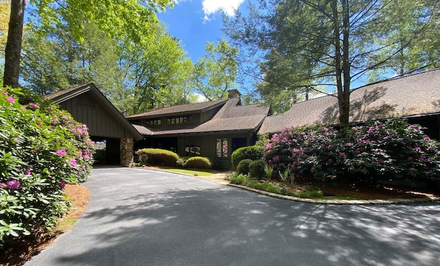 1747 Cold Mountain Rd, Lake Toxaway, NC 28747 - view of front of home featuring board and batten siding, driveway, and a chimney