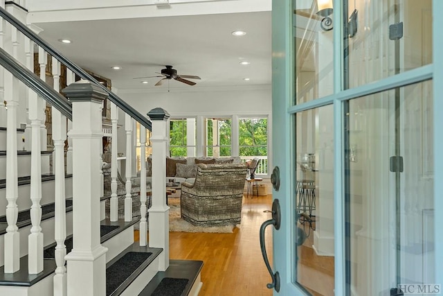 interior space featuring crown molding, light hardwood / wood-style floors, and ceiling fan