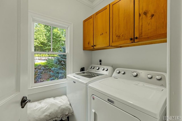 clothes washing area with cabinets, ornamental molding, and washing machine and dryer