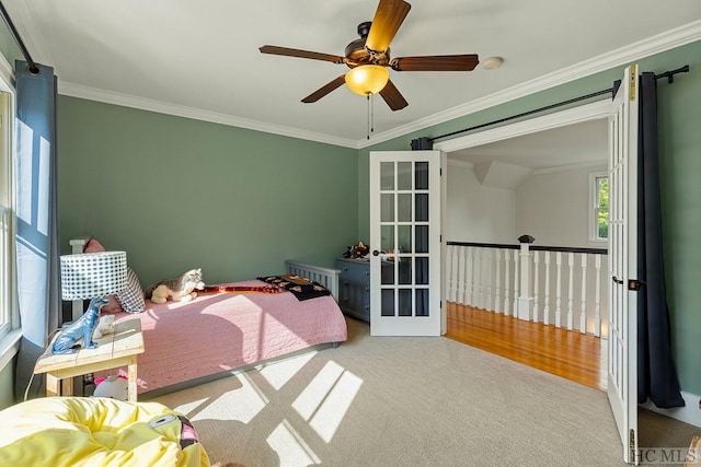 carpeted bedroom featuring ornamental molding, vaulted ceiling, ceiling fan, and french doors